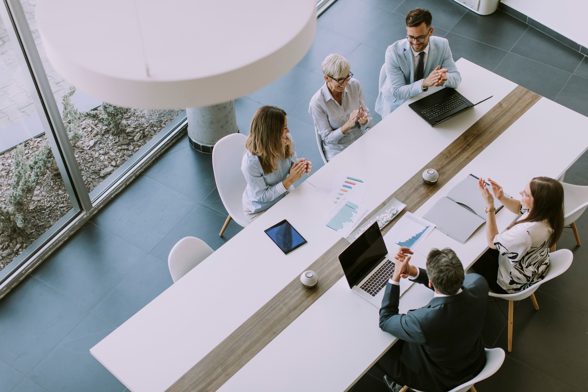 AuditScribe empowers organisations through collaboration and clear communication, as seen in this image of a team working together to achieve success.